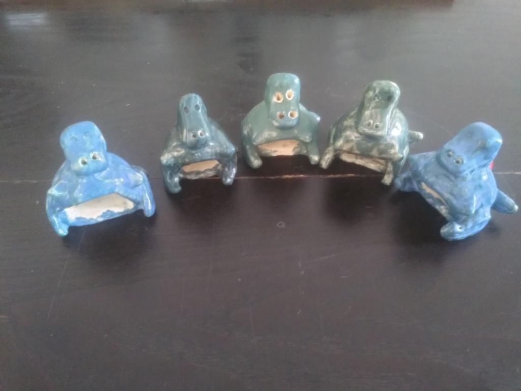 5 cute tiny dragons seen from the front, they form a half circle looking at the centre.