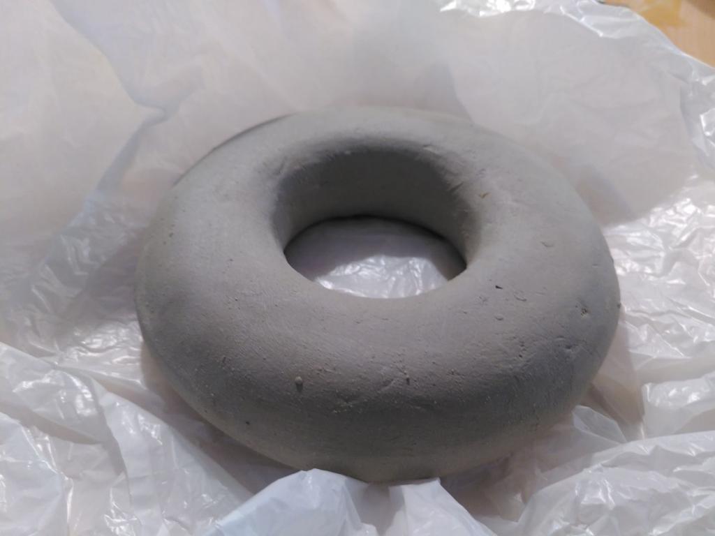 Picture of a clay doughnut on a plastic, the picture is taken looking about 45 degrees upwards from the doughnut and it produces very satisfying shading.