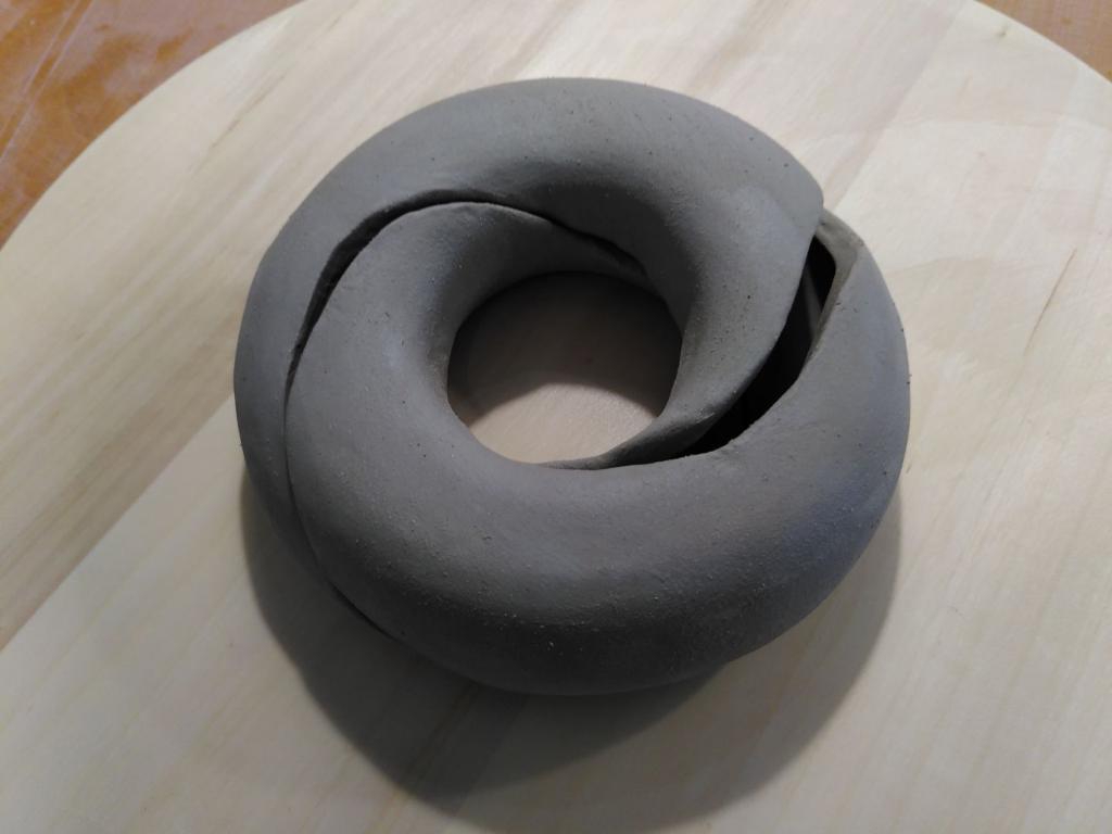 The doughnut, before baking freshly cut. Since it is not even leather hard (the interior was sealed, so it was quite wet still), it is very fragile and so it is tricky to show the interlaced pieces.