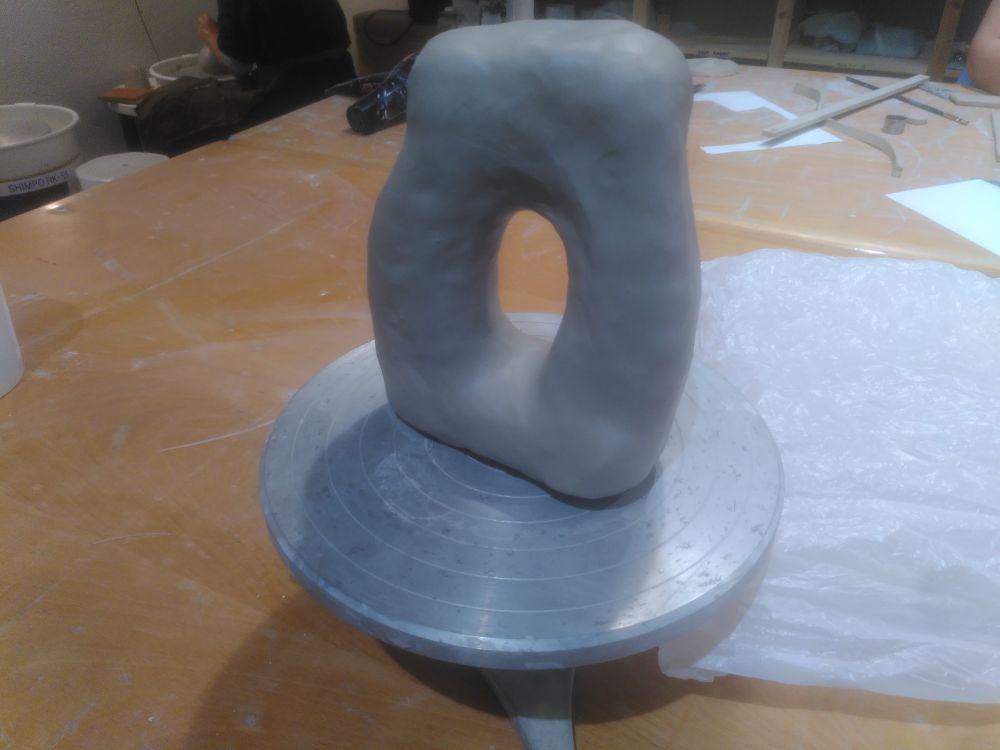 A somewhat oblong shape with a hole in the middle.
At this stage, the piece is SOLID, and can't be baked like that.