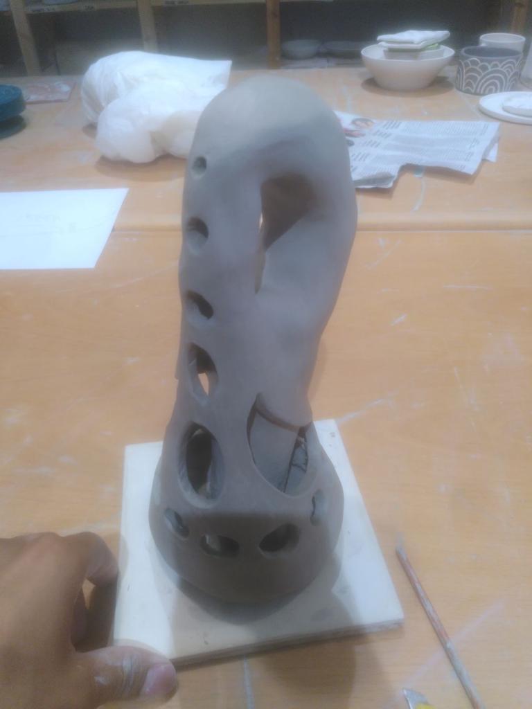 The described Klein bottle pointing at 8 o'clock, in order to actually see the effect, it has big see-through holes in front and to the sides.