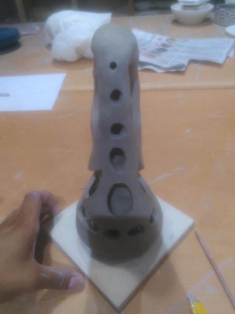 The Klein bottle pointing at 6 o'clock, the holes give it a bit of an alien or inter-galactic vibe.