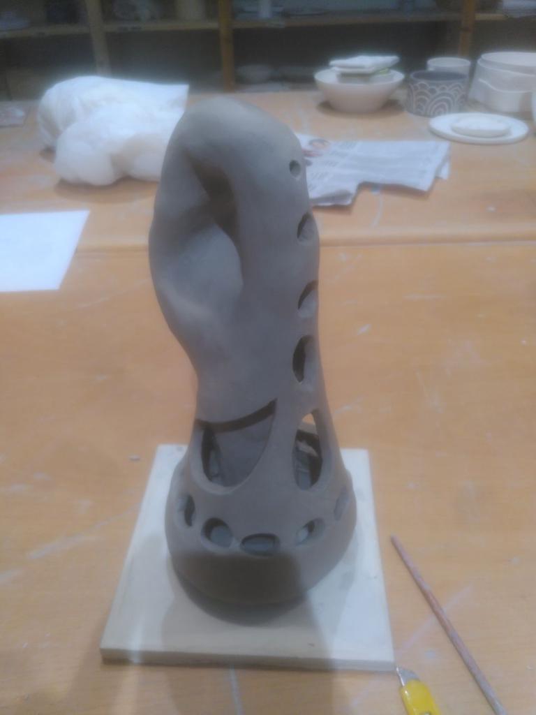 The Klein bottle pointing at 4 o'clock, we appreciate here how the spaces are fully inter-connected.