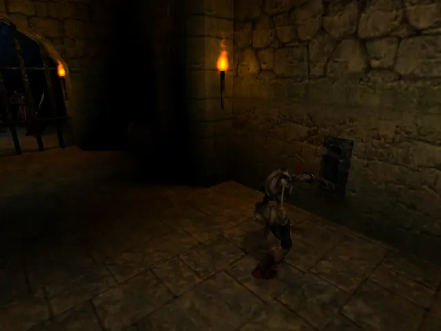 Un cos sense cap, de peu davant d'una palanca, activant-la.

De fons la nostra cela, amb nosaltres dins.