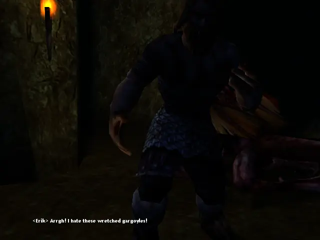 Erik amb una Gàrgola al terra en una masmorra més aviat fosca.